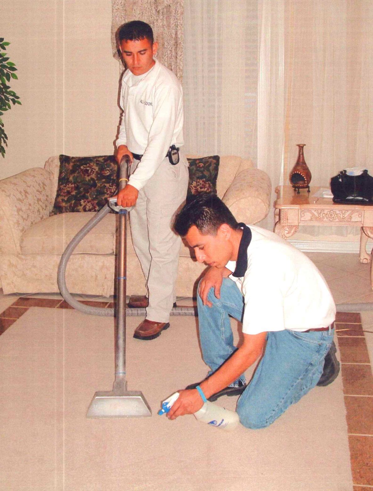 Two technicians steam cleaning a carpet, 2003