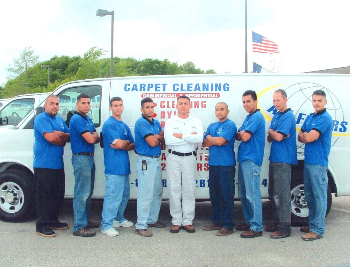 The original All Floors crew in front of a company van, 2003