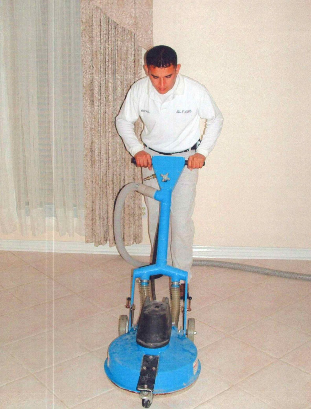 Technician operating a tile cleaning machine